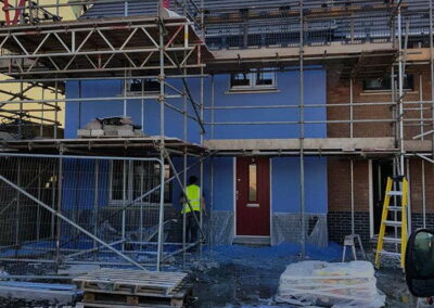 Blue Coloured Spray Render Residential Estate Fishguard - APW Homes