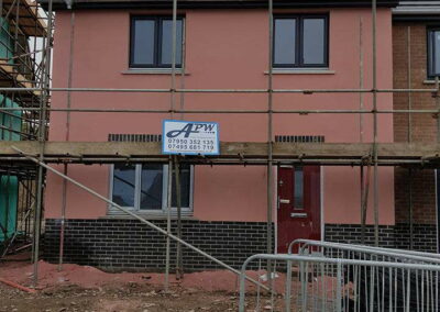 Peach Coloured Spray Render Residential Estate Fishguard - APW Homes